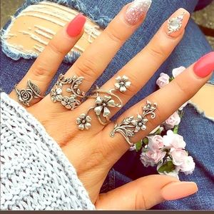 Set of four floral themed rings